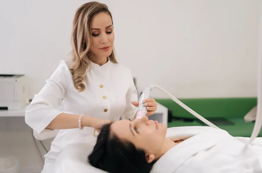 A aesthetic clinician performing a facial skin treatment on a woman